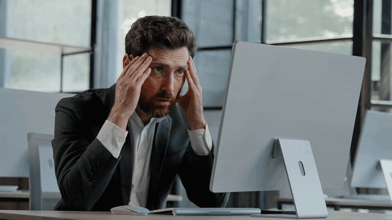 Stressed man looking at his computer