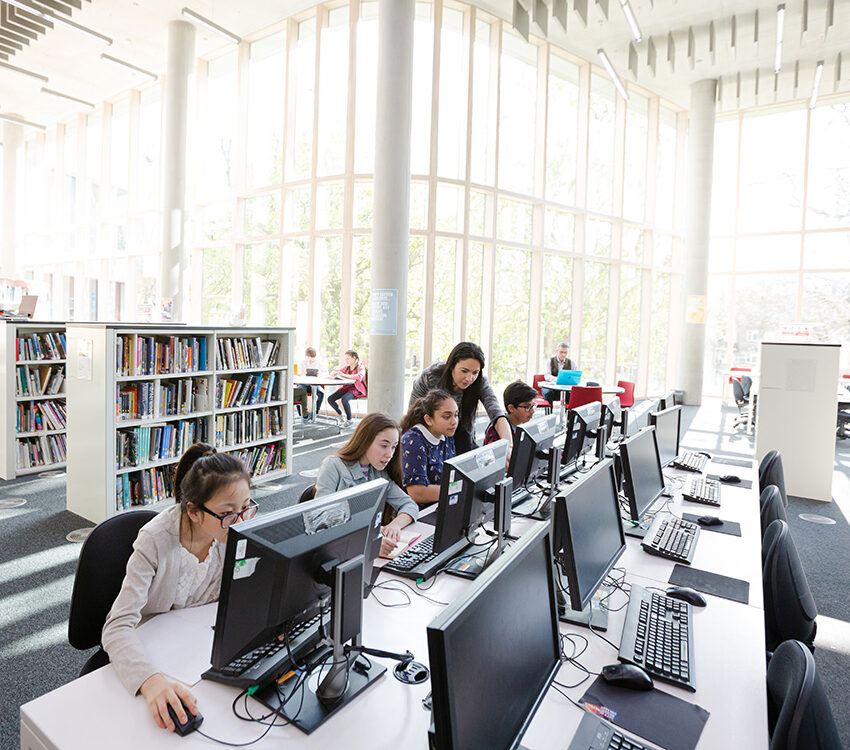 Students working on computers in library