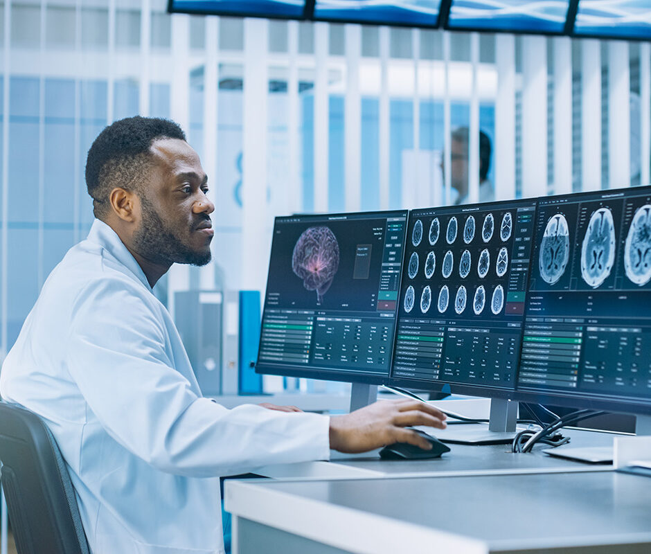 Medical Scientist Working with CT Brain Scan Images on a Persona