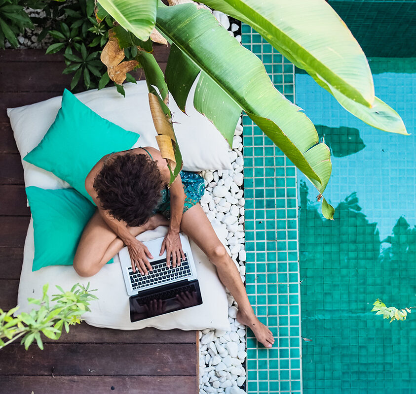 Woman working by the pool