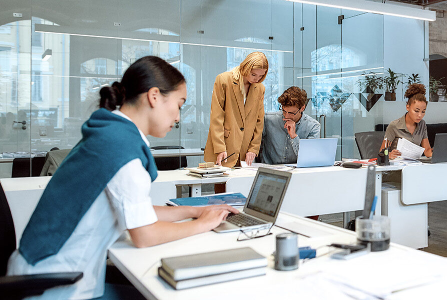 Group of business people working together in the creative co-working space.