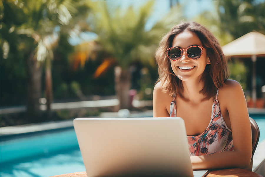 Happy female freelancer using her laptop.